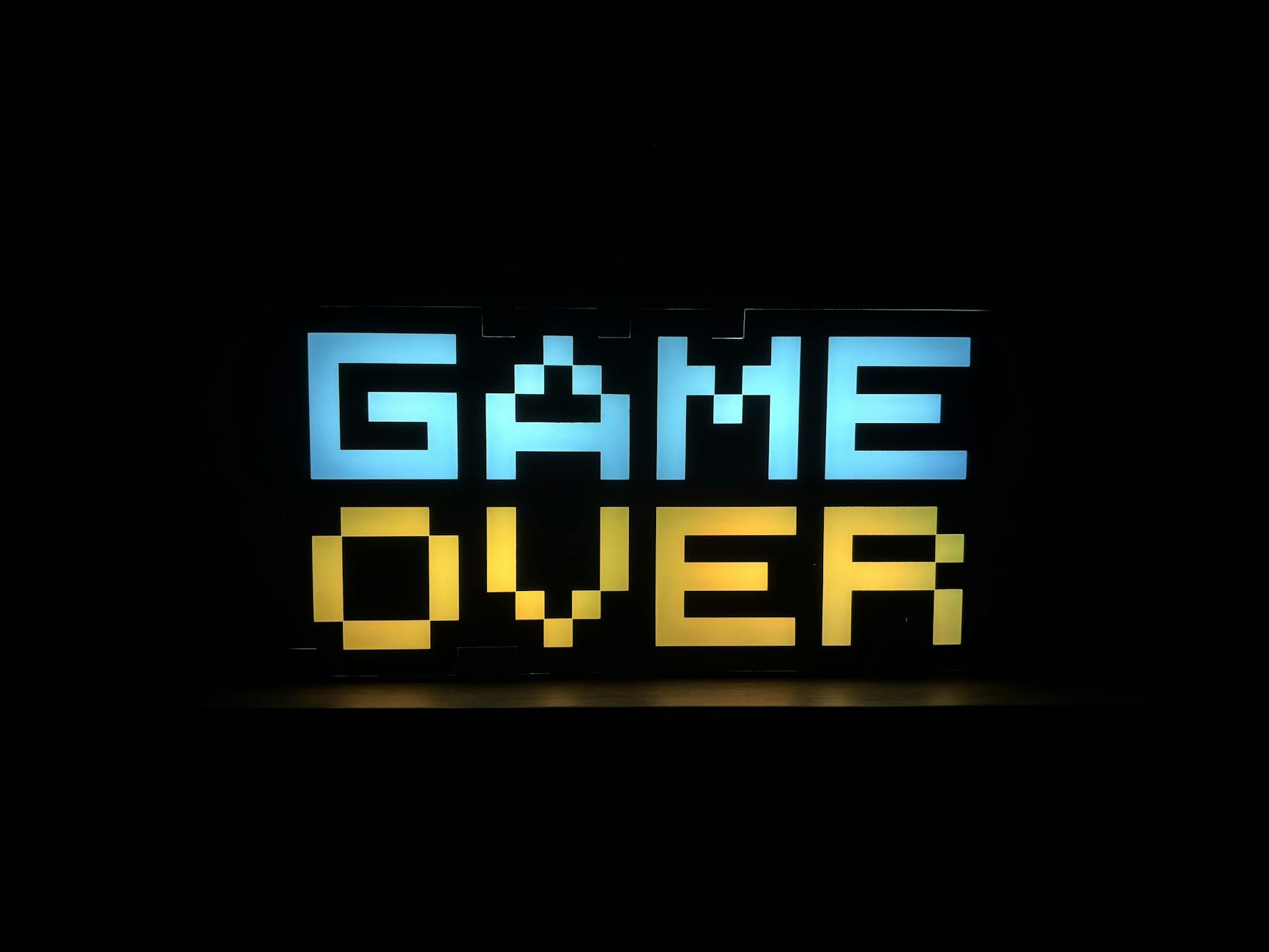 pixel art game over neon sign in darkness